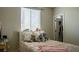 Comfortable bedroom with a large window, soft pillows, and a charming collection of stuffed animals at 11731 Longworth Rd, Las Vegas, NV 89135