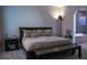 Cozy bedroom with a neutral color palette, dark wood furnishings, and ensuite bathroom at 11731 Longworth Rd, Las Vegas, NV 89135