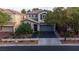 Charming two-story home showcasing landscaped front yard and a two car garage at 11731 Longworth Rd, Las Vegas, NV 89135