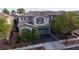 An elevated view of a two-story home with a well-maintained front yard and a two-car garage at 11731 Longworth Rd, Las Vegas, NV 89135