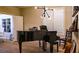 Living Room features a grand piano, modern lighting, and hardwood floors, adjacent to the office at 11731 Longworth Rd, Las Vegas, NV 89135