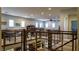 This loft features a metal railing, multiple windows, and plentiful seating and entertaining options at 11731 Longworth Rd, Las Vegas, NV 89135