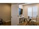 Well-lit office space features a sleek glass desk, modern chair and built-in shelving with shutters at 11731 Longworth Rd, Las Vegas, NV 89135
