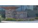 Stone sign for Allerton Park with flowers that mark the tranquil entrance at 11731 Longworth Rd, Las Vegas, NV 89135