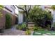 Lush side yard with brick-lined walkway and mature trees at 11731 Longworth Rd, Las Vegas, NV 89135