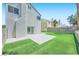 An exterior shot of a backyard with a concrete patio and artificial grass for easy maintenance at 1501 Lucia Dr, Las Vegas, NV 89128