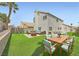 Spacious backyard with outdoor seating area, lush lawn, and a fire pit for entertaining at 1501 Lucia Dr, Las Vegas, NV 89128