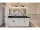 Modern bathroom with double vanity, sleek mirrors, and a soaking tub at 1501 Lucia Dr, Las Vegas, NV 89128