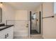Modern bathroom features a tub, walk-in shower with black hardware, and black framed mirror at 1501 Lucia Dr, Las Vegas, NV 89128
