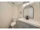 Charming bathroom with a modern vanity, an oval mirror, and updated fixtures at 1501 Lucia Dr, Las Vegas, NV 89128