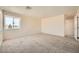 A bright, carpeted bedroom with a window and neutral paint at 1501 Lucia Dr, Las Vegas, NV 89128