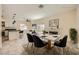 Open-concept dining area with modern light fixture, fireplace and kitchen island at 1501 Lucia Dr, Las Vegas, NV 89128