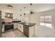 Open kitchen layout with stainless steel appliances, granite counters, and island sink at 1501 Lucia Dr, Las Vegas, NV 89128