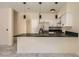 Open kitchen with black countertops, stainless steel appliances and pendant lighting at 1501 Lucia Dr, Las Vegas, NV 89128