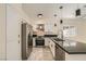 Modern kitchen with stainless steel appliances, granite countertops, and white cabinetry at 1501 Lucia Dr, Las Vegas, NV 89128