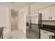 Bright modern kitchen with stainless steel refrigerator, tile floors and black granite countertops at 1501 Lucia Dr, Las Vegas, NV 89128