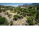 Lush residential property featuring a cozy home amidst mature trees, picturesque views, and a tranquil setting at 18480 State Hwy 160, Las Vegas, NV 89161