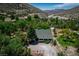 Cabin in the Nevada Mountains nestled among lush greenery and rock features, perfect for quiet living at 18480 State Hwy 160, Las Vegas, NV 89161