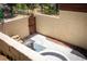 Private backyard patio with an in-ground hot tub, seating area, and enclosed wall at 18480 State Hwy 160, Las Vegas, NV 89161