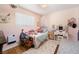 Charming bedroom with pink accents, decorated with personal touches and plenty of stuffed animals at 18480 State Hwy 160, Las Vegas, NV 89161