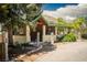 Quaint single-story home with a covered porch, stone pillars, and mature landscaping at 18480 State Hwy 160, Las Vegas, NV 89161