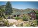 Charming home with green roof, neutral exterior, and mature landscaping in a rural setting at 18480 State Hwy 160, Las Vegas, NV 89161