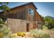 Exterior shot of a two-story wooden building with a rustic charm, featuring a unique block wall addition at 18480 State Hwy 160, Las Vegas, NV 89161