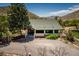 Charming bungalow-style house with a well-maintained yard and a gravel driveway surrounded by nature at 18480 State Hwy 160, Las Vegas, NV 89161