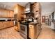Well-lit kitchen with stainless steel appliances, wooden cabinets, and brick details at 18480 State Hwy 160, Las Vegas, NV 89161