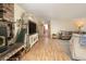 Bright and open living room featuring a brick fireplace, entertainment center, and cozy seating area at 18480 State Hwy 160, Las Vegas, NV 89161