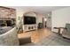 Inviting living room showcases hardwood floors, a brick fireplace, and a decorative entertainment center at 18480 State Hwy 160, Las Vegas, NV 89161