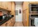 Well-organized pantry with wood cabinets, stainless appliances, and ample storage space at 18480 State Hwy 160, Las Vegas, NV 89161