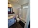 Well-lit bathroom featuring a granite countertop, toilet, and tiled shower and bathtub combo with wood plank flooring at 1870 Upland Ave, Pahrump, NV 89048