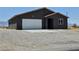 Charming single-story home with a white garage door and low maintenance desert landscaping at 1870 Upland Ave, Pahrump, NV 89048