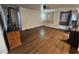 A spacious living room is enhanced by wood plank flooring, ceiling fan, and a refrigerator in the corner at 1870 Upland Ave, Pahrump, NV 89048