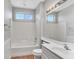 Bathroom featuring a tiled shower, a large mirror, and white wainscoting at 1941 Williamsport St, Henderson, NV 89052