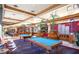 Community billiard room featuring multiple pool tables, lounge seating, and interior design elements at 1941 Williamsport St, Henderson, NV 89052