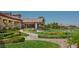 Scenic clubhouse with manicured lawns, verdant landscaping, decorative hedges, and walking paths at 1941 Williamsport St, Henderson, NV 89052