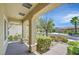Inviting front porch with stone pillars, verdant landscaping, and a view of the neighborhood at 1941 Williamsport St, Henderson, NV 89052