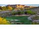 Stunning golf course view featuring a sand trap, putting green, signage, and lush green trees at 1941 Williamsport St, Henderson, NV 89052