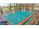 Large indoor swimming pool with lane markers, surrounded by tables, chairs, and large windows at 1941 Williamsport St, Henderson, NV 89052