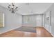 Spacious living room with hardwood floors, a decorative chandelier, and ample natural light at 1941 Williamsport St, Henderson, NV 89052