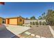 Spacious backyard with concrete patio area, landscaped features, and a shed for extra storage at 1950 Abarth St, Las Vegas, NV 89142