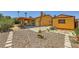 Extensive backyard showcasing patio, storage shed, decorative wind spinner, and rock features at 1950 Abarth St, Las Vegas, NV 89142