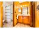 A full bathroom featuring a shower, tile floor, and wood paneling at 1950 Abarth St, Las Vegas, NV 89142