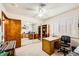 A comfortable bedroom features a ceiling fan, desk, shelves, and decor at 1950 Abarth St, Las Vegas, NV 89142
