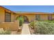 Inviting home exterior featuring a beautiful arched entryway and well-manicured landscaping at 1950 Abarth St, Las Vegas, NV 89142