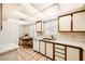 A functional kitchen features white cabinets, solid surface countertops, tile flooring and ample natural light at 1950 Abarth St, Las Vegas, NV 89142