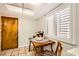 Bright kitchen nook with a wooden door, table and chair, complemented by plenty of natural light from the adjacent window at 1950 Abarth St, Las Vegas, NV 89142
