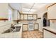 An open kitchen area with solid surface countertops, white cabinets, modern appliances and ample workspace for cooking at 1950 Abarth St, Las Vegas, NV 89142